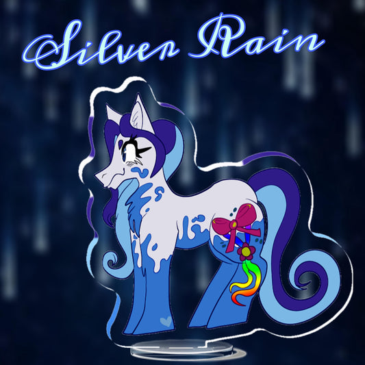 Silver Rain - Standee Mockup
A Misty Blue Gray earth pony with Mariner Blue splotches on her underbelly, neck, cheeks, hooves, and legs. She has a two toned Tech Navy Blue & Aero Blue mane and tail that curl inward like ribbons. Her Cutie Mark is a large Flamboyant Pink bow with two rainbow ombre ribbons hanging down her leg, held together with a Palace Magenta flower holding them together.